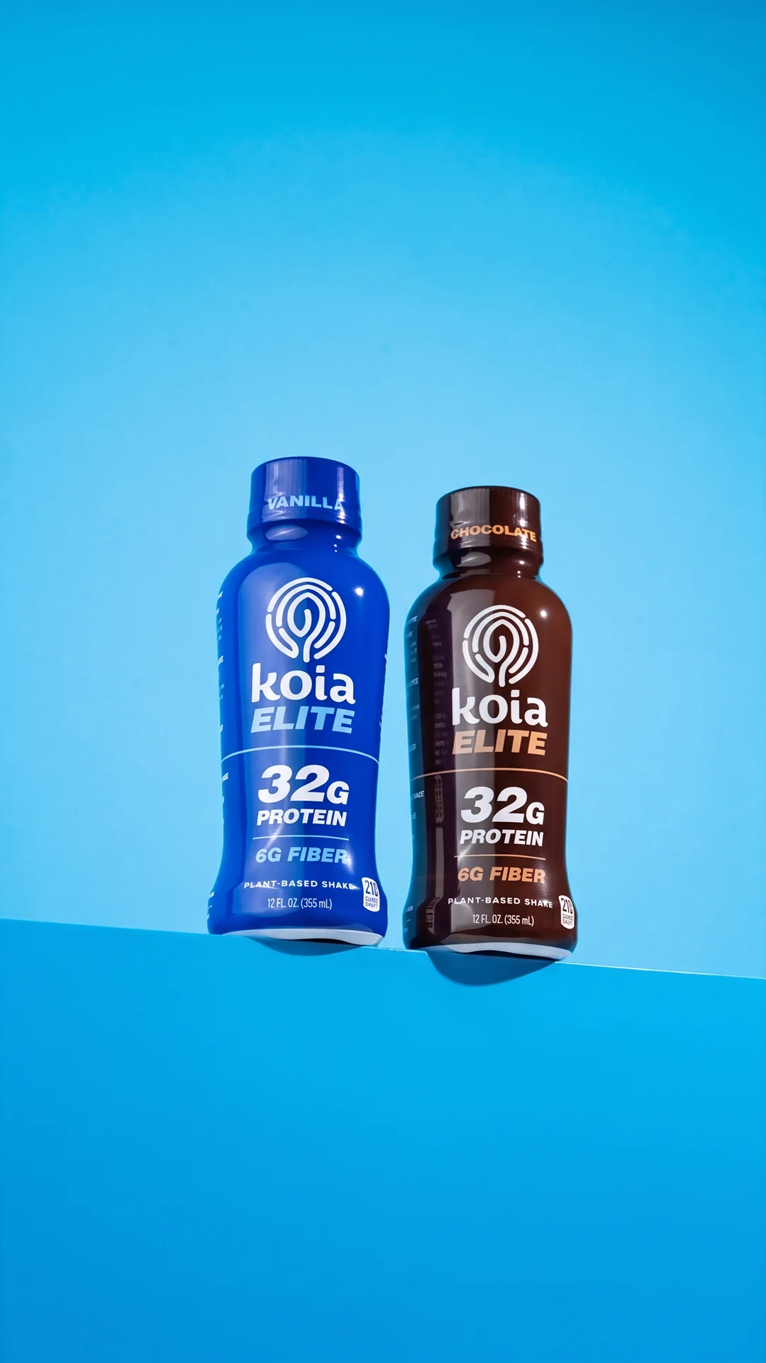 Koia Elite protein shake bottles on a blue backdrop