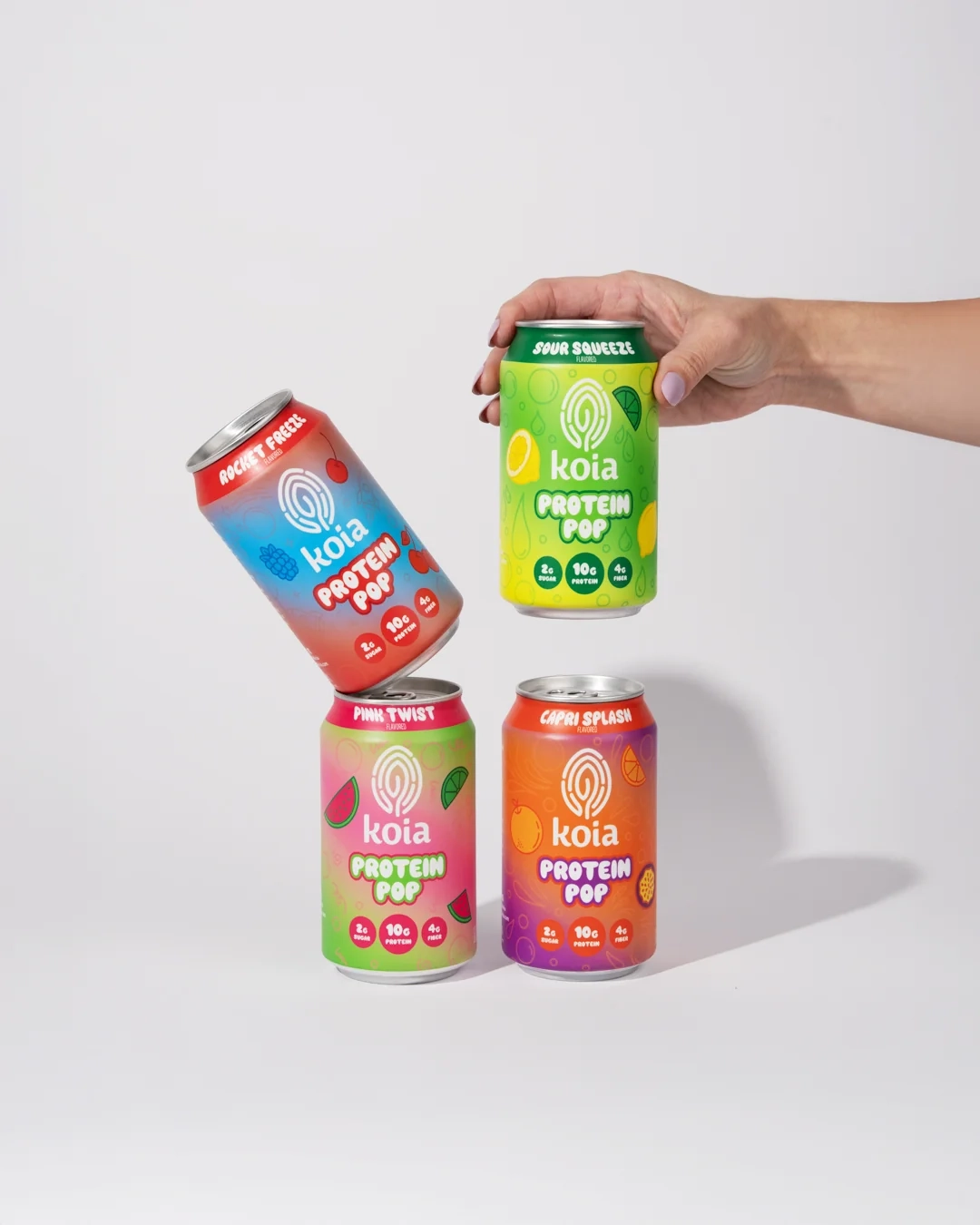 Koia protein pop cans stacked in a hand